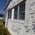 Paint Brick Siding while working 